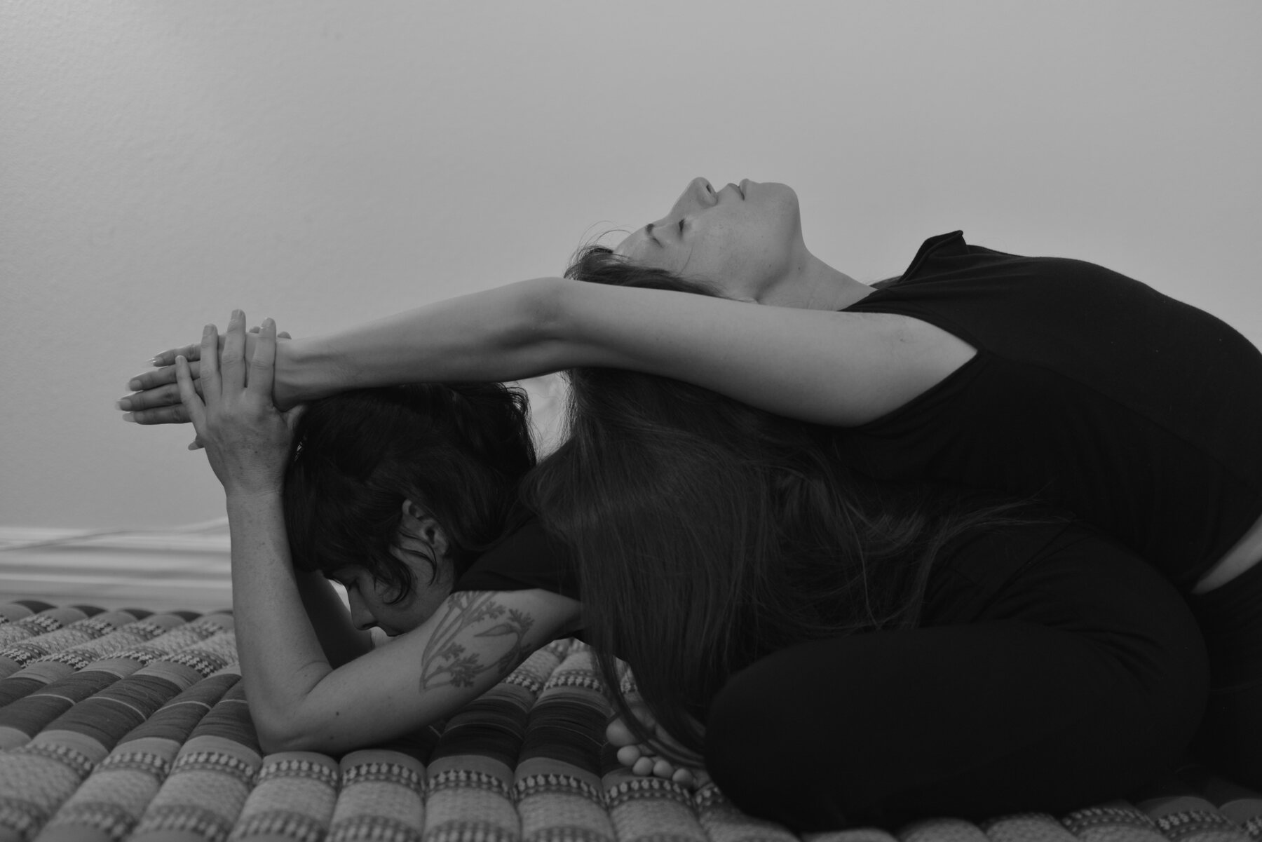 Holly guiding a supported stretch during an individual yoga session