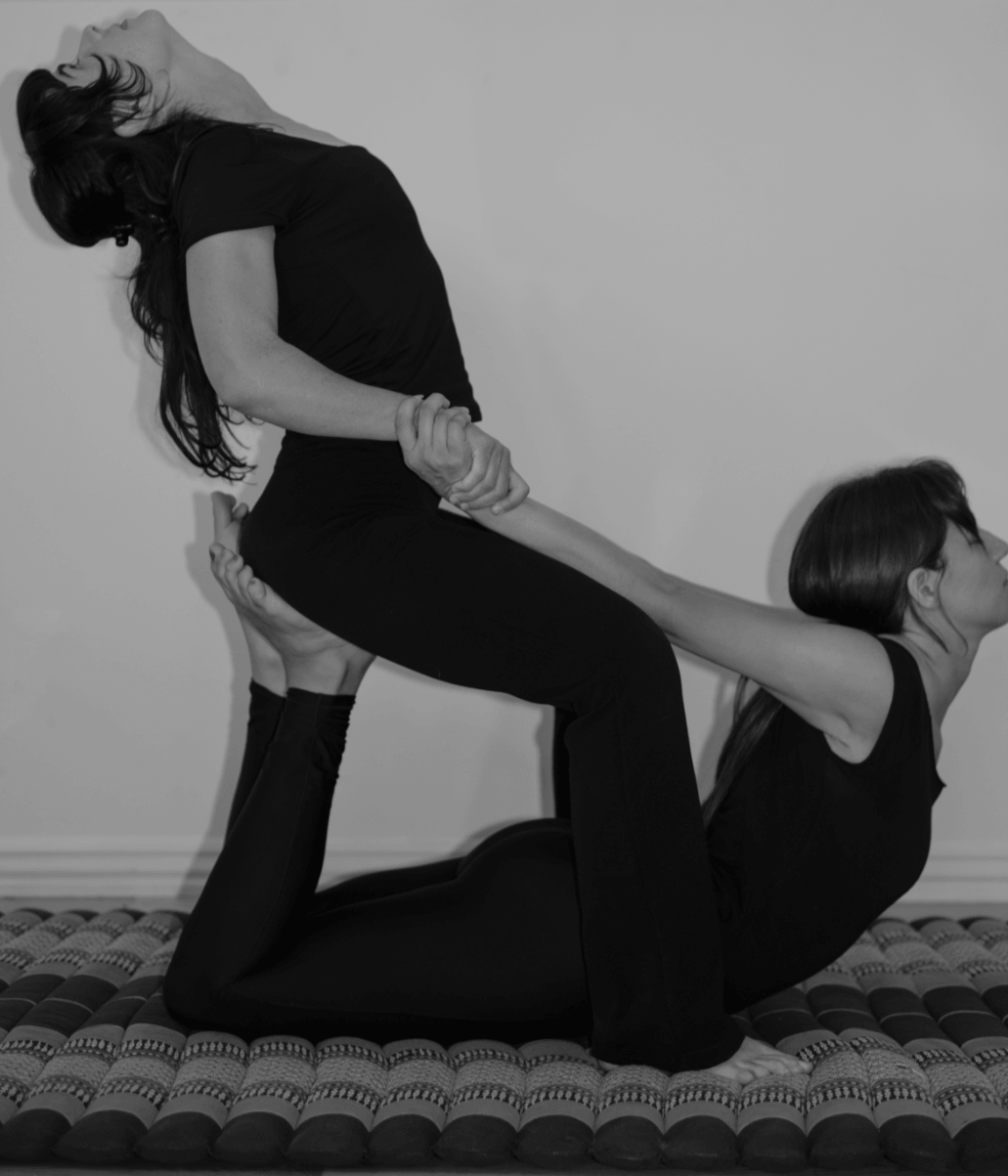 A supported partner yoga backbend