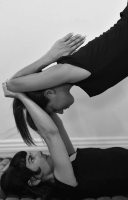 A client supported in a folded therapeutic flying pose